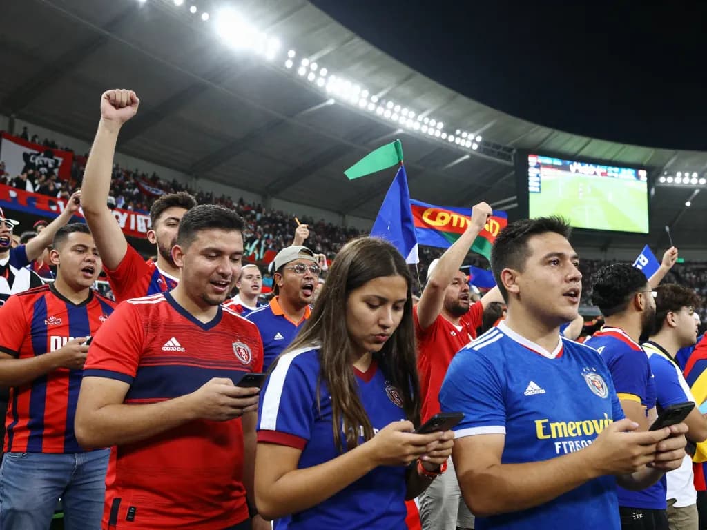 Fans celebrating during a football match on Nowgoal, showcasing live excitement and dynamic atmosphere.