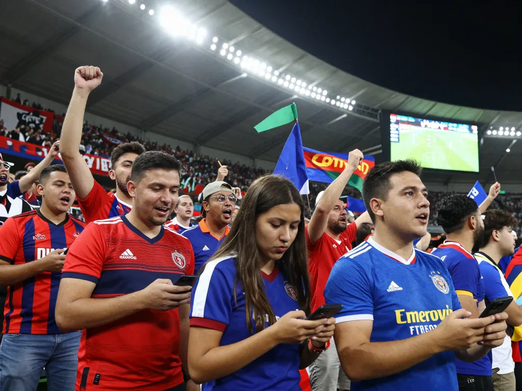 Fans celebrating during a football match on Nowgoal, showcasing live excitement and dynamic atmosphere.
